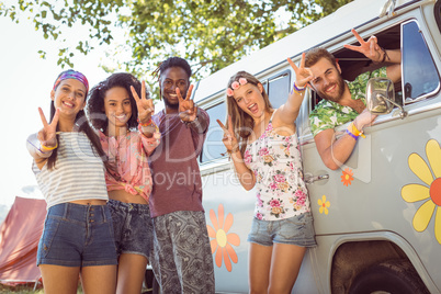 Hipsters smiling at camera in campsite