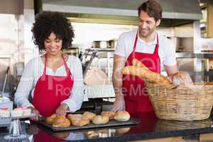 Cheerful colleagues posing with bread