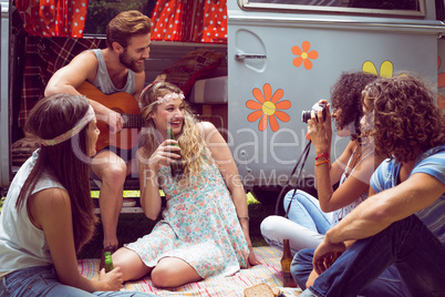 Hipster friends by camper van at festival