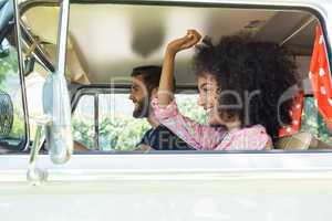 Hipster couple driving in camper van