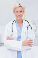 Female doctor with arms crossed standing in clinic