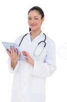 Happy doctor using her tablet pc