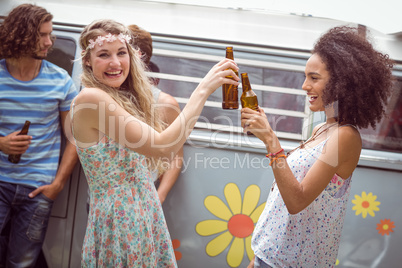 Pretty hipsters toasting with beer