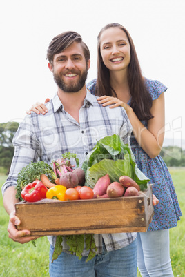 Happy couple with box of veg