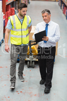 Warehouse worker talking with his manager