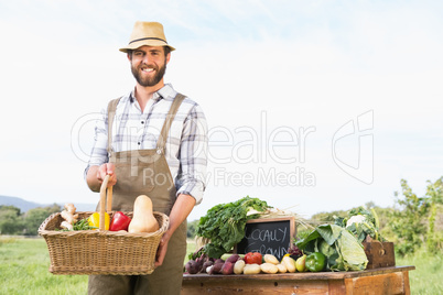 Farmer holding basket of vegetables at market