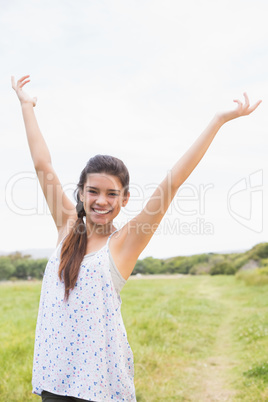 Pretty brunette feeling free in the park