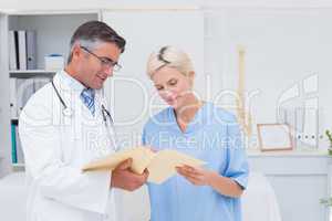 Doctor and nurse discussing over reports