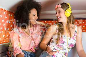 Happy friends on a road trip using listening to music