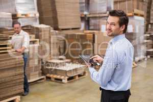 Warehouse manager working on tablet pc