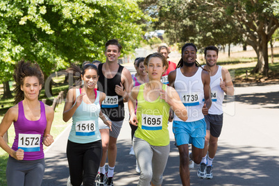 Happy people running race in park