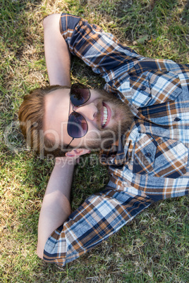 Handsome hipster relaxing in the park