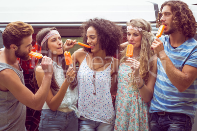 Hipster friends enjoying ice lollies