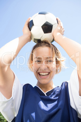 Pretty football player smiling at camera