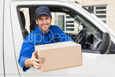 Delivery driver offering parcel from his van