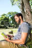 Hipster reading a book in the park