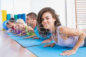 Woman with friends practicing push-ups