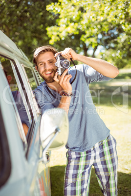 Handsome hipster taking a photo