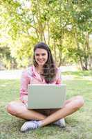 Woman using laptop in park