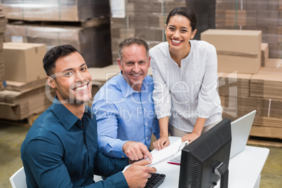 Warehouse team smiling at camera