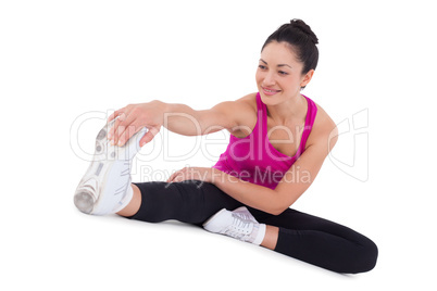 Fit woman stretching her legs