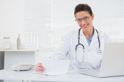 Doctor looking at clipboard