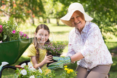 Happy grandmother with her granddaughter gardening