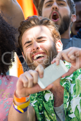 Excited music fan taking photo