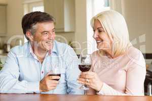 Happy mature couple drinking red wine