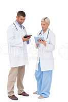 Doctors discussing something on clipboard