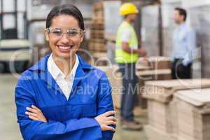 Manager wearing protective mask looking at camera