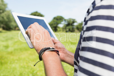 Man using a tablet in the park Man using a tablet in the park