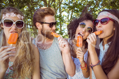 Hipster friends enjoying ice lollies