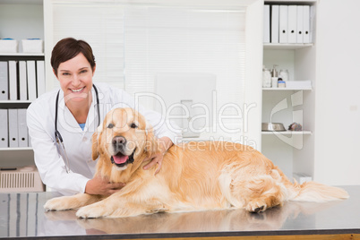 Smiling veterinarian examining a cute dog