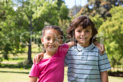 Little siblings smiling at camera