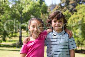 Little siblings smiling at camera