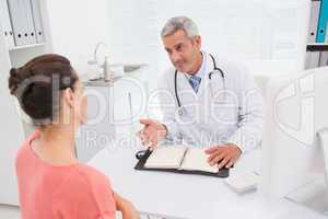Patient consulting a happy doctor