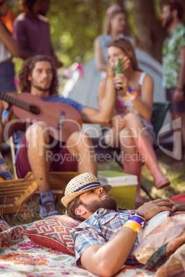 Handsome hipster relaxing on campsite Handsome hipster relaxing on campsite