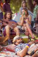 Handsome hipster relaxing on campsite