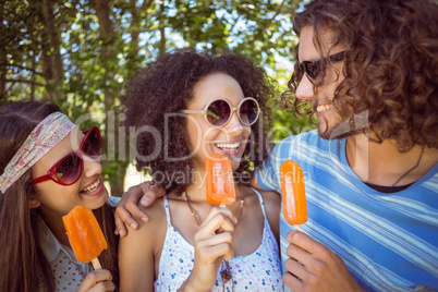 Hipster friends enjoying ice lollies