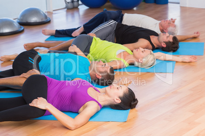 People stretching legs in fitness studio