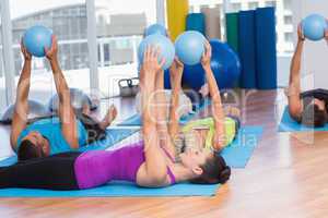 People with medicine ball in fitness studio