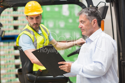Forklift driver talking with his manager
