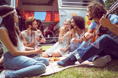 Hipster friends by camper van at festival