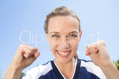 Pretty football player smiling at camera