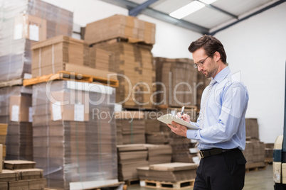 Warehouse manager checking his inventory