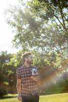 Handsome hipster using vintage camera