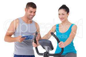 Trainer with client on exercise bike