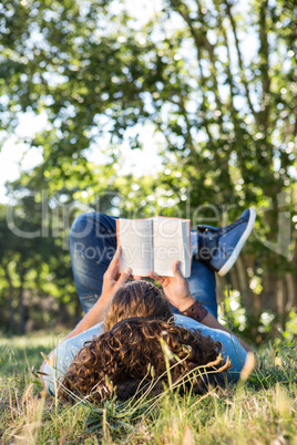 Young man reading book in the park