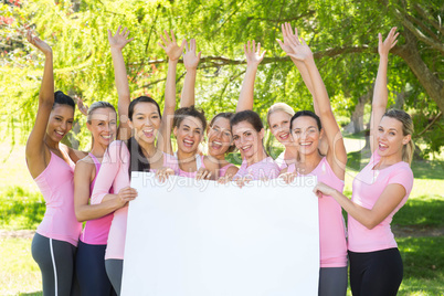 Smiling women in pink for breast cancer awareness